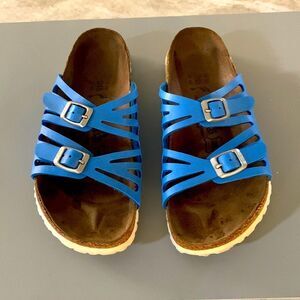 Bright blue buckled Birkies by Birkenstock.